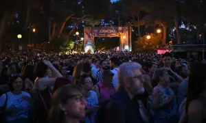 Multitud disfrutando de música al raso Zaragoza bajo un arco de agradecimiento.