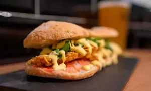 Un bocadillo generoso con pollo crujiente, salsa y rúcula, uno de los mejores bocadillos de Zaragoza.