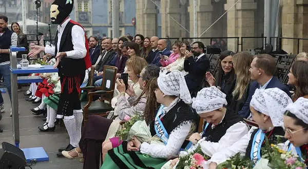 Presentación del programa fiestas delicias con un hombre enmascarado y público atento.