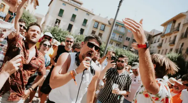 Un cantante con micrófono anima a la multitud en un festival. Gente con pulseras de acceso, un verdadero amante festival.