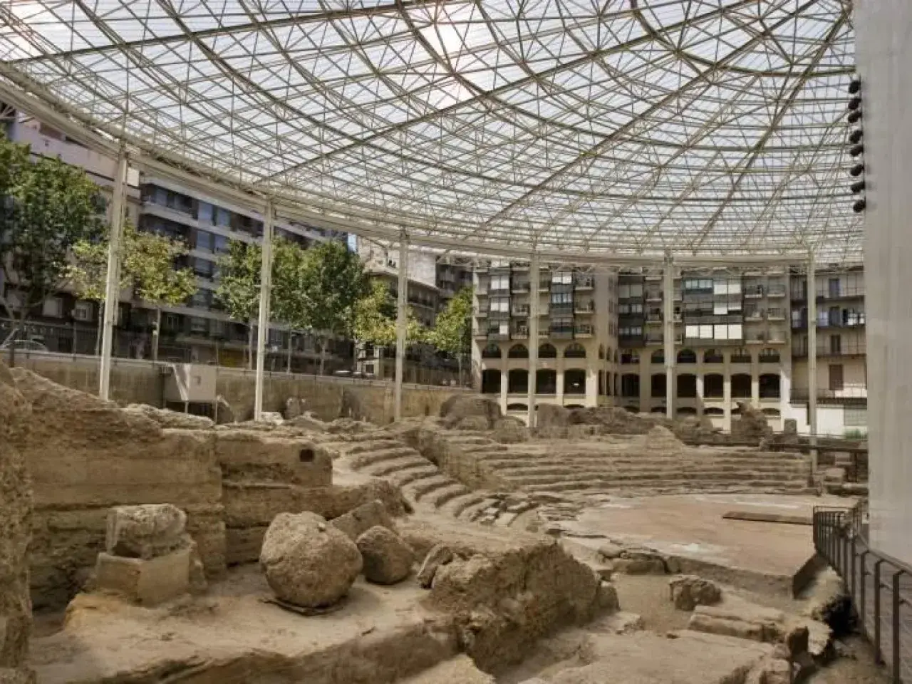 Ruinas del teatro romano de la ruta Caesaraugusta, cubiertas por una estructura metálica y de cristal.