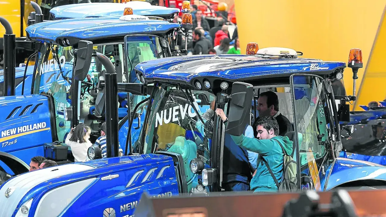 Tractores New Holland en la FIMA Zaragoza 2026. Personas observan los nuevos modelos, algunos niños curiosos se asoman.